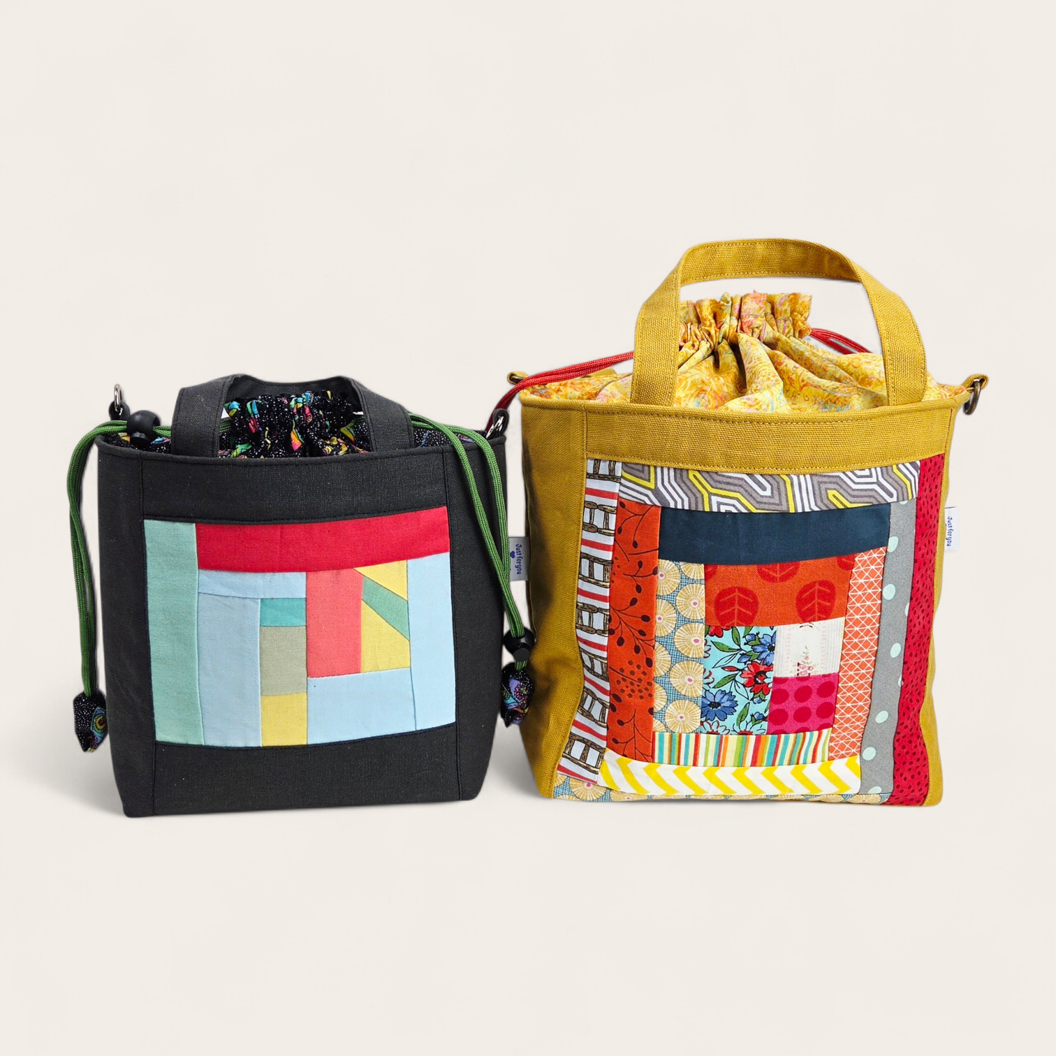 Two colorful fabric bags with patchwork designs on a light beige background